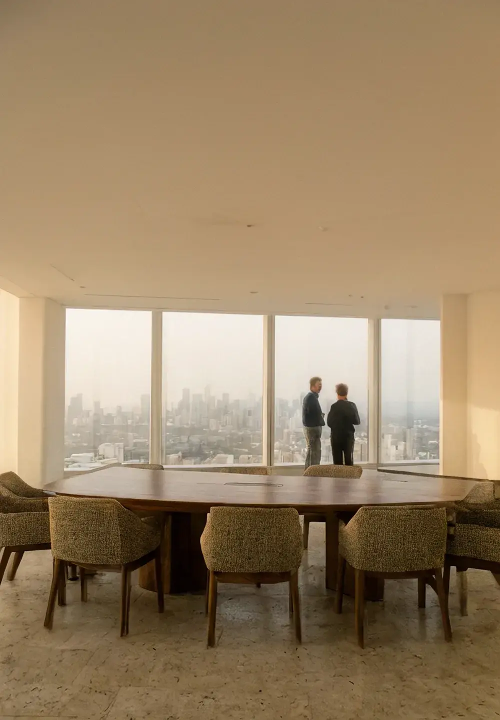 A composed health-system executive by floor-to-ceiling windows